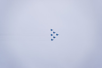 Air show in the sky above the Krasnodar airport flight school. Airshow in honor of Defender of the Fatherland. MiG-29 in the sky.