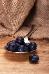 Blueberries and spoon on a rustic background