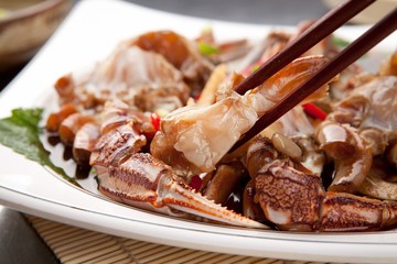 soy sauce marinated crab with chopsticks	