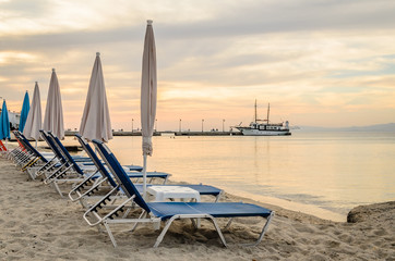Fototapeta na wymiar Deck chairs on the beach in Pefkochori