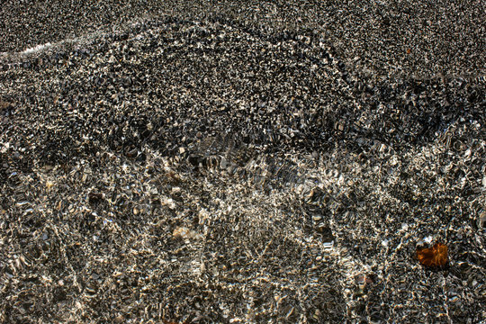 Abstract grey shingle and water