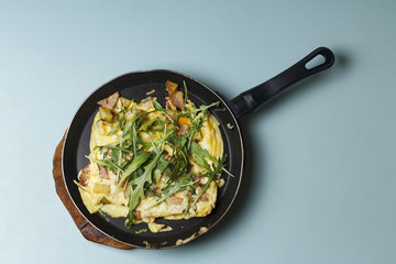 Breakfast. Bacon arugula with eggs in a frying pan. Healthy lifestyle