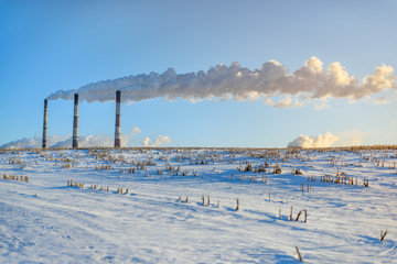 Pipes Factory on a background of winter field