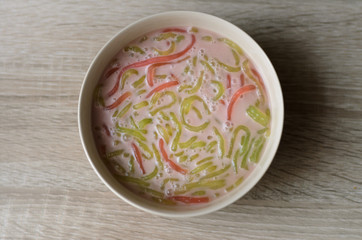 Thai dessert,Bowl of dessert made of flour rice with coconut milk on wooden table,flavor sweet asian style