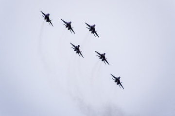 Air show in the sky above the Krasnodar airport flight school. Airshow in honor of Defender of the Fatherland. MiG-29 in the sky.
