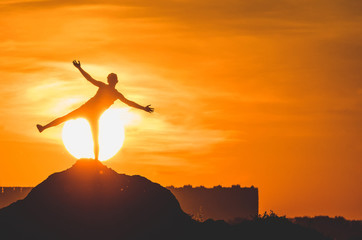 Human silhouette jumping at solar disk sunny summer sunset drive holidays and vacations