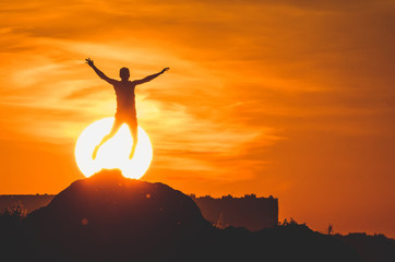 Human silhouette jumping at solar disk sunny summer sunset drive holidays and vacations