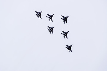 Air show in the sky above the Krasnodar airport flight school. Airshow in honor of Defender of the Fatherland. MiG-29 in the sky.