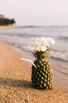 Cocktail in a pineapple on the sea