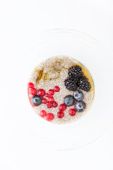 healthy vegan dessert with chia seeds pudding, cranberry, fresh blueberry and blackberries with  Maple syrup. Clean eating, dieting, detox, vegetarian food concept