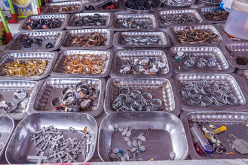 Display of different sized finger rings placed on plates in a street shop for sale, Chennai, India, Feb 19 2017