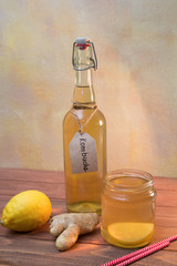 Vintage bottle and jar with Kombucha tea with lemon and ginger