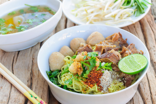 Thai - Chinese style spicy noodle with steamed pork and pork ball served with fresh vegetable and soup