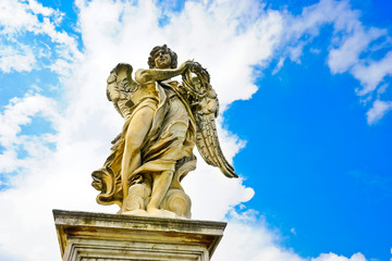 The statue of angel figure on the Aelian Bridgein in Rome in a sunny day.