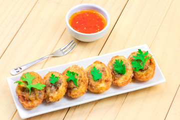 Traditional northern Thai style food, fried egg with pork inside. Made from mixed boiled egg and pork with ingredient the put all in half egg shell and fry it call 