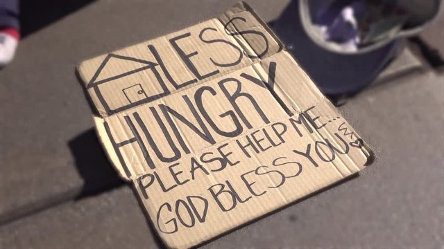 Homeless and Hungry sign on cardboard asking for money