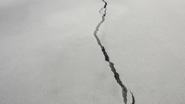Research vessel in icy arctic sea on a sunny day