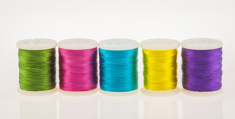 Row of colorful bright thread and bobbin