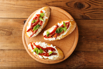 Italian sandwiches - bruschetta with cheese, tomato and basil. Top view