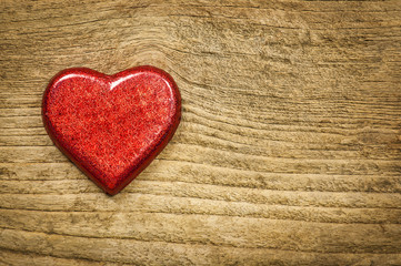 Red heart chocolate on old wooden background