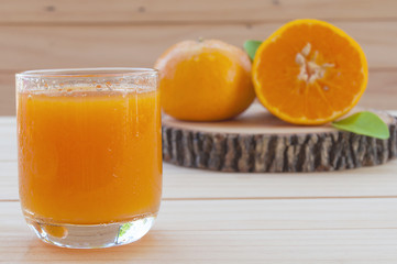 Cold orange juice on wooden table