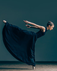 Young beautiful dancer posing in studio