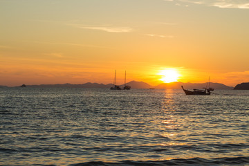 Fototapeta na wymiar Sunset and traditional thai long boat around seaside, Ao Nang, Krabi province, Thailand