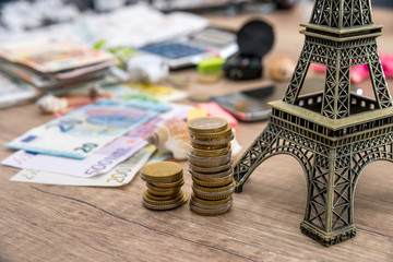 Eiffel Tower with euro money on desk. travel concept.