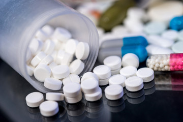 pills in container for health. Pharmacy theme. close up.