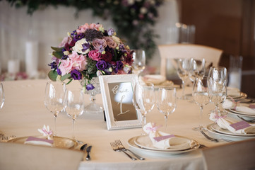 Wedding table with candles, flowers and sign number