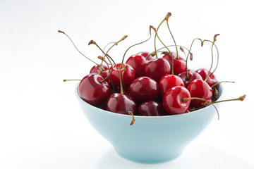 bowl of fresh cherries on a white background, closeup