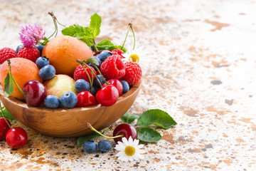 bowl with seasonal fruit and berries on table, closeup