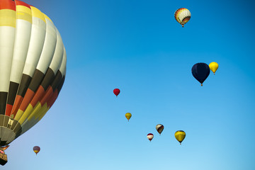 Start of big hot air balloons at the field with cool cloudy sky