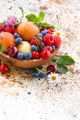 bowl with seasonal fruit and berries, vertical closeup