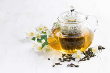 green tea with jasmin on white wooden background