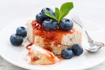 piece of cheesecake with berry jam, closeup