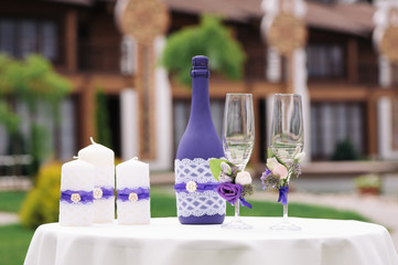 Wedding decorated glasses and champagne bottles on table