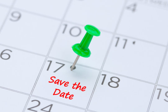 Save the Date written on a calendar with a green push pin to remind you and important appointment.