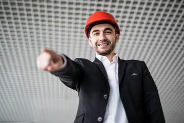 Young architect pointing at you