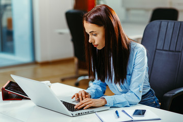 Young business women working on laptop in the office