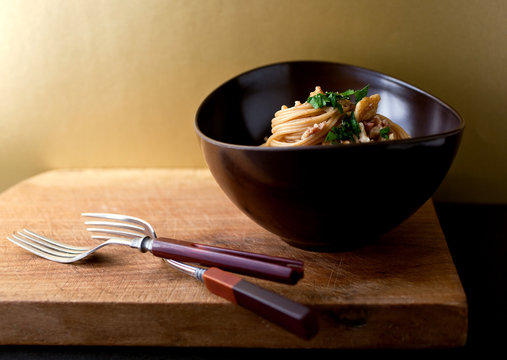 Spaghetti with walnuts and anchovies in bowl