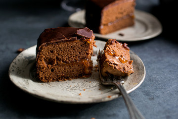 Slice of on white plate with fork, close-up
