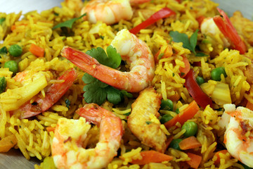 Udon stir-fry rice with shrimp and vegetables in wok pan on black burned stone background