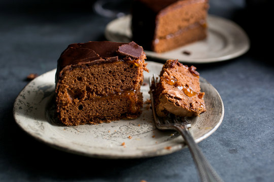 Slice of on white plate with fork, close-up