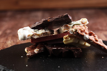 Melting chocolate and diffrent bars - stack and chips with chocolate swirl/ powder and cocoa pod with melted chocolate