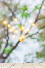 Blur abstract of light bokeh with tree branch background with white wooden terrace