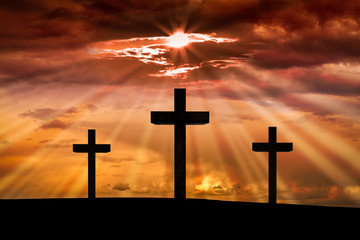 Jesus Christ cross on a background with dramatic sky,lighting,red, orange...