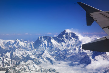 Himalaya mountains Everest and Lhotse, with snow flags and clouds, view from plane - obrazy, fototapety, plakaty