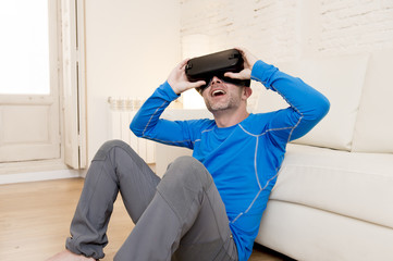 Obraz premium happy man at home living room sofa couch excited using 3d goggles watching 360 virtual reality