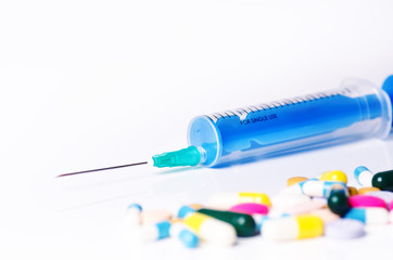 Medical equipment. Injection isolated on a white background with reflection and pills. Pharmacy...